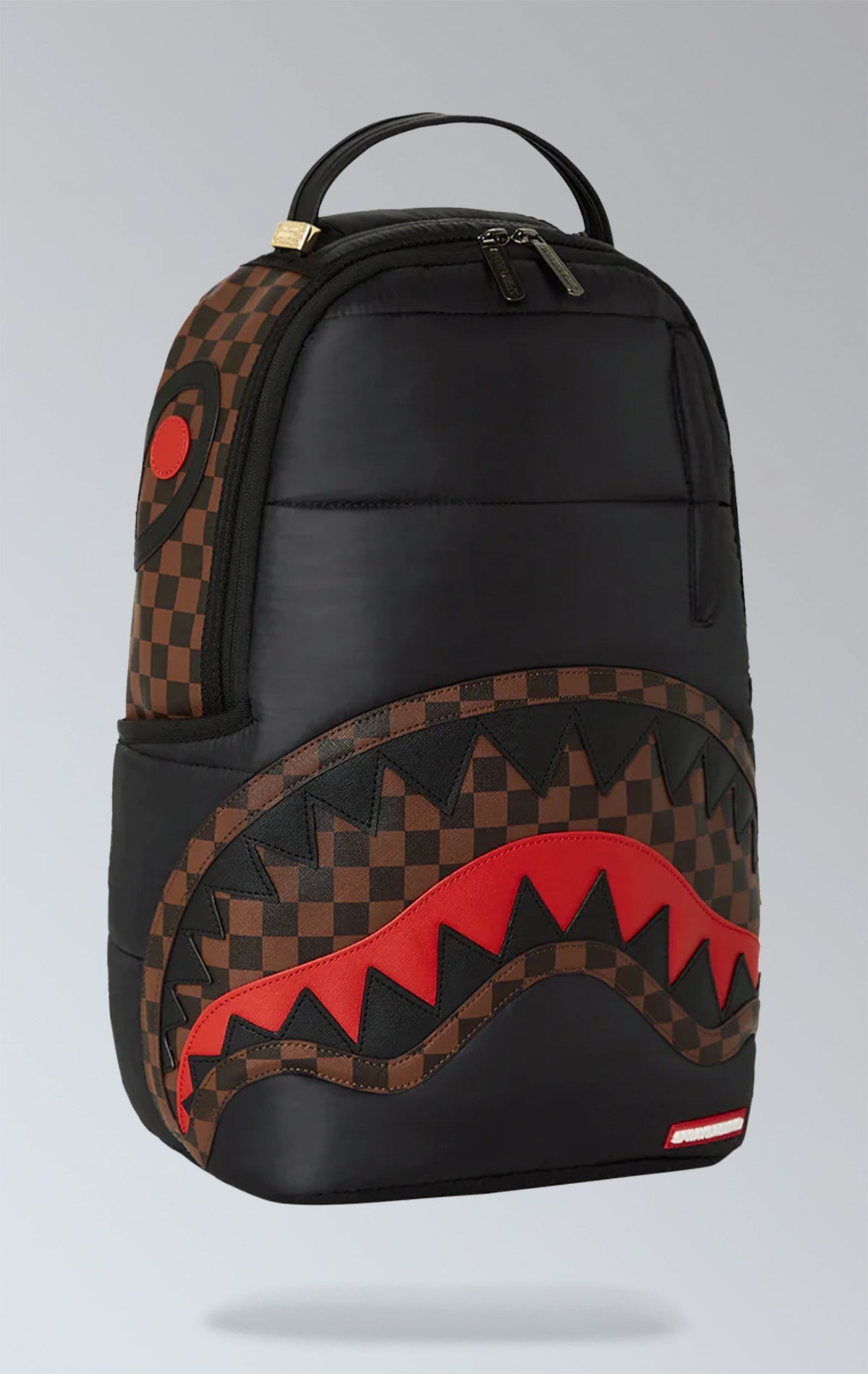 Black Sprayground backpack with a horizontal quilted puffer jacket-inspired design. Features multiple compartments including a separate velour laptop compartment, side pockets, and a hidden zippered pocket.  Equipped with ergonomic mesh back padding, adjustable straps, and a sliding back sleeve for attaching to carry-on luggage. Made from durable 100% polyester techy fabric with horizontal quilting.